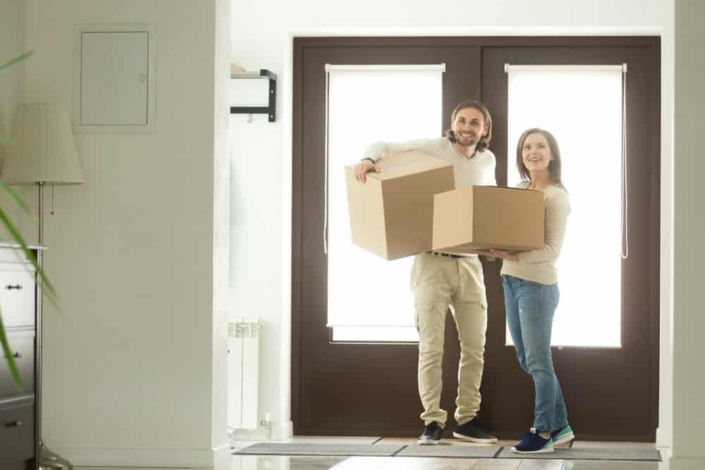 Couple Carrying Boxes — Removalist in Brisbane, QLD