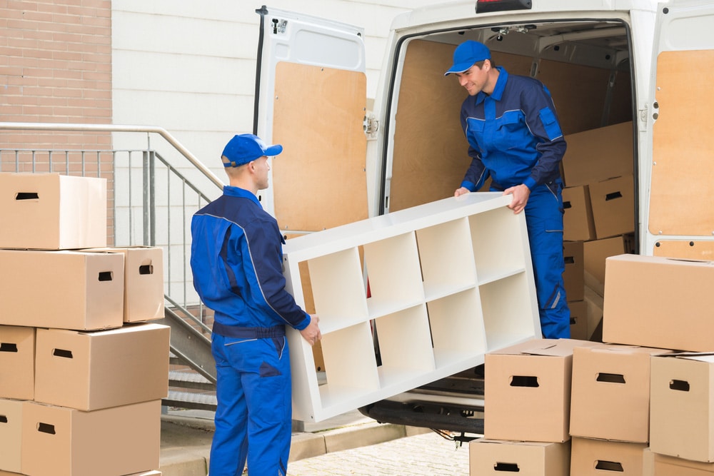 Young Male Movers Unloading Furniture