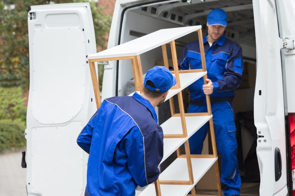 Movers Loading A Shelf In The Van