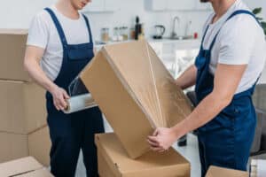 two removalist packing and organising the boxes